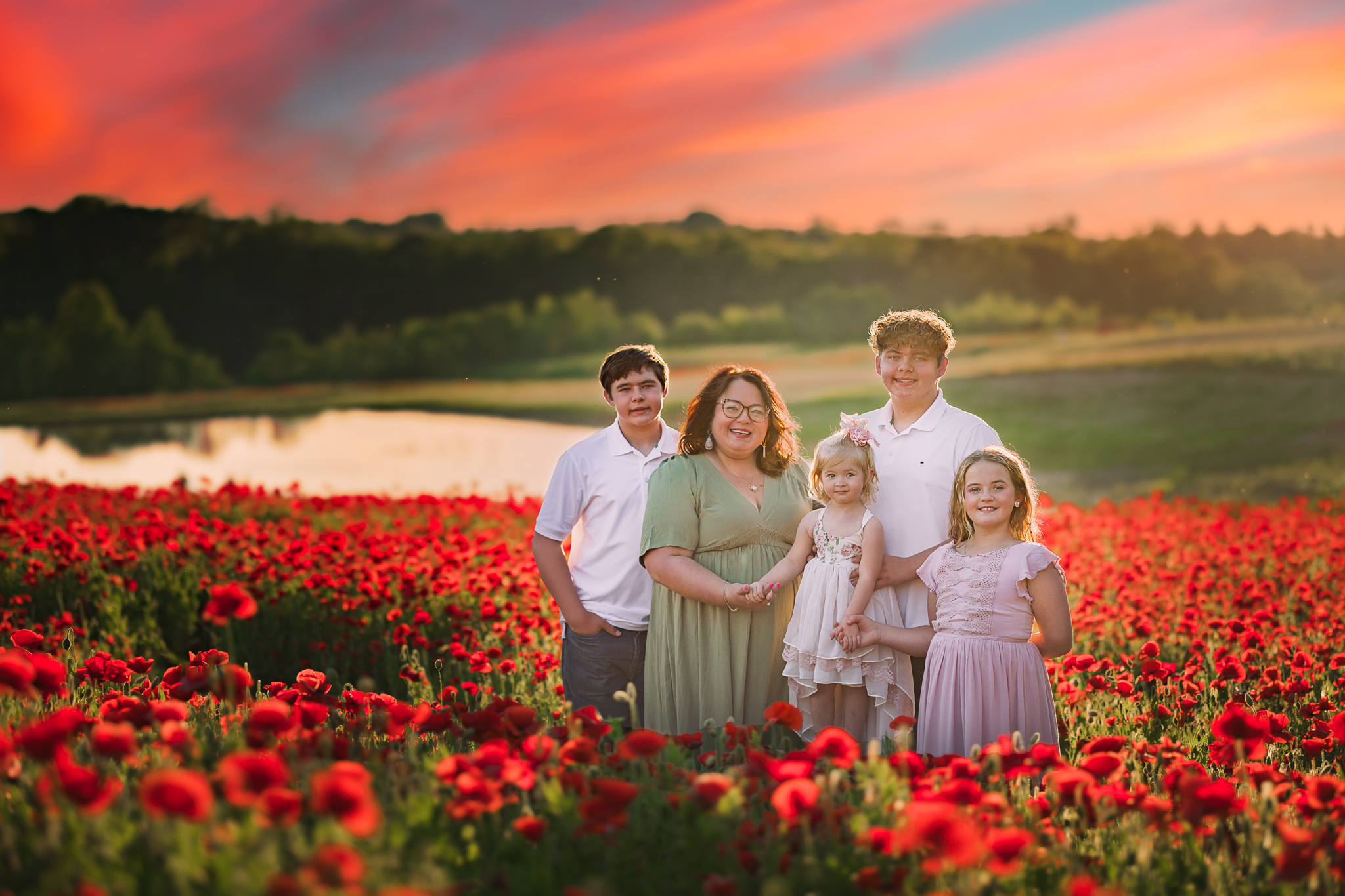 mom and her children in a beautiful field of red poppies