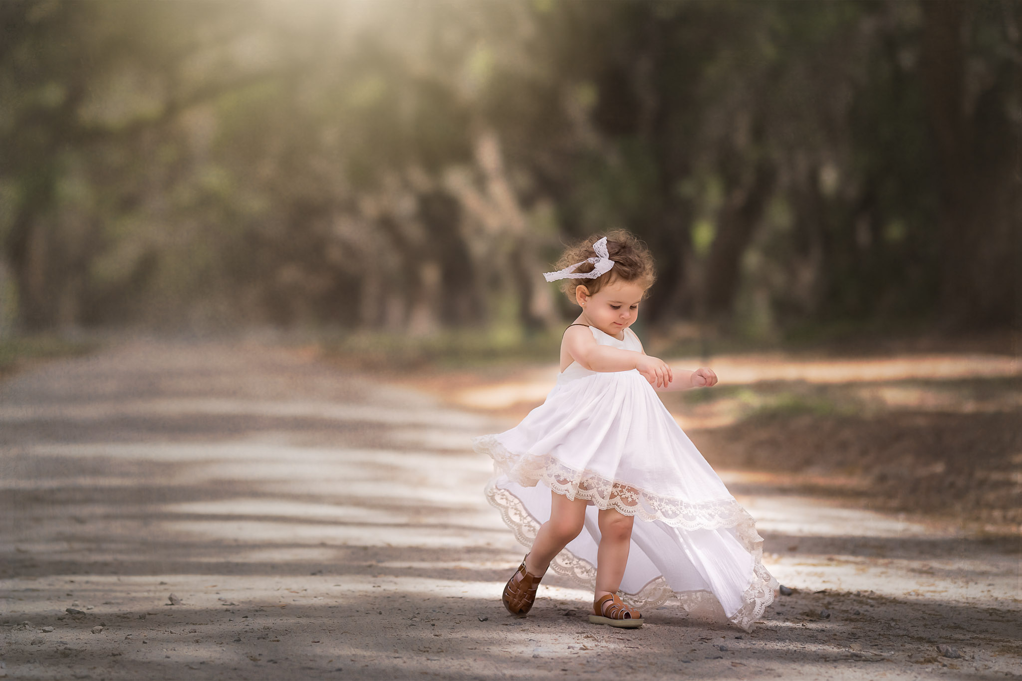 A little girl twirling in a pretty white dress in anticipation of the best Raleigh preschools
