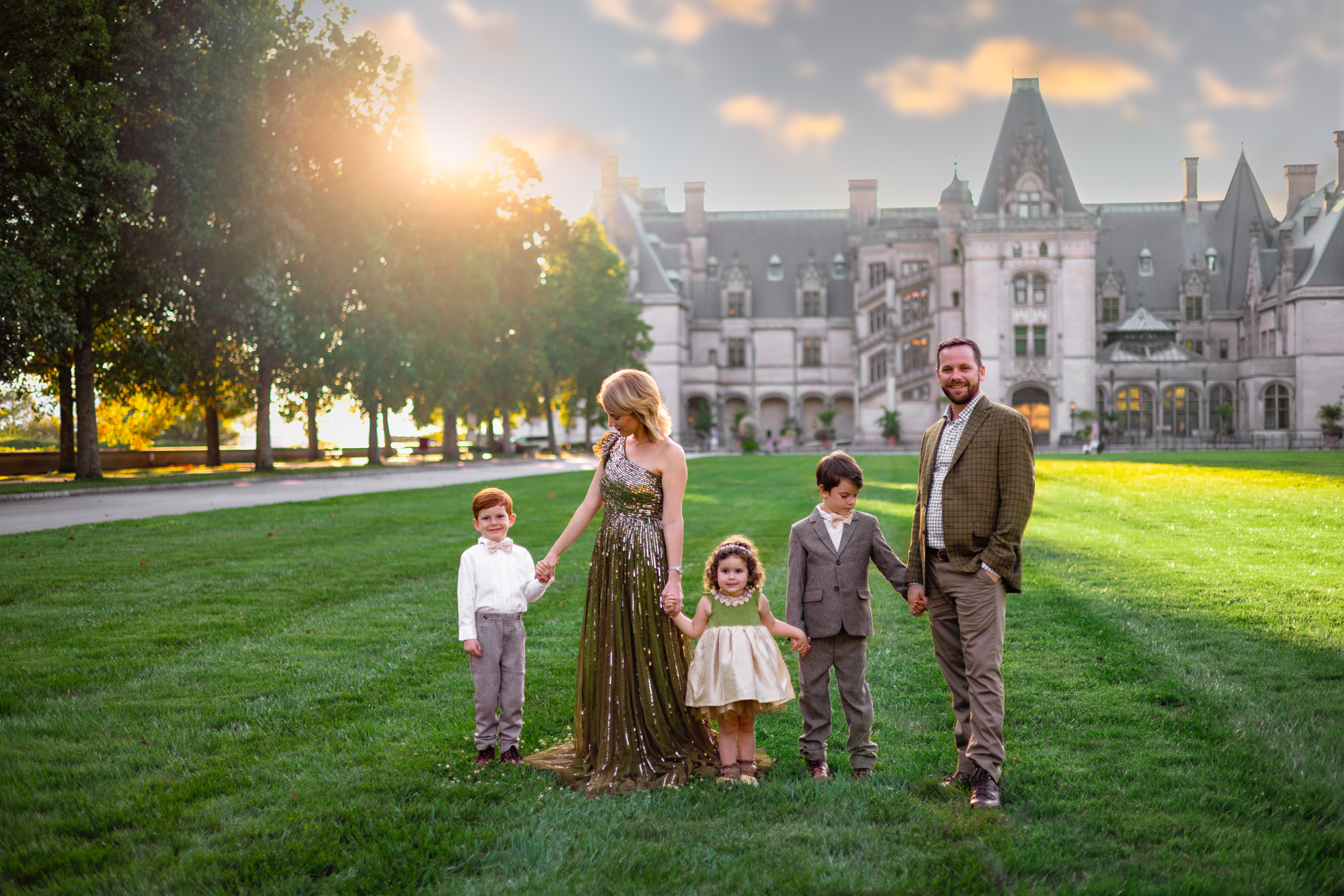 a family holding hands in front of the Biltmore Estates