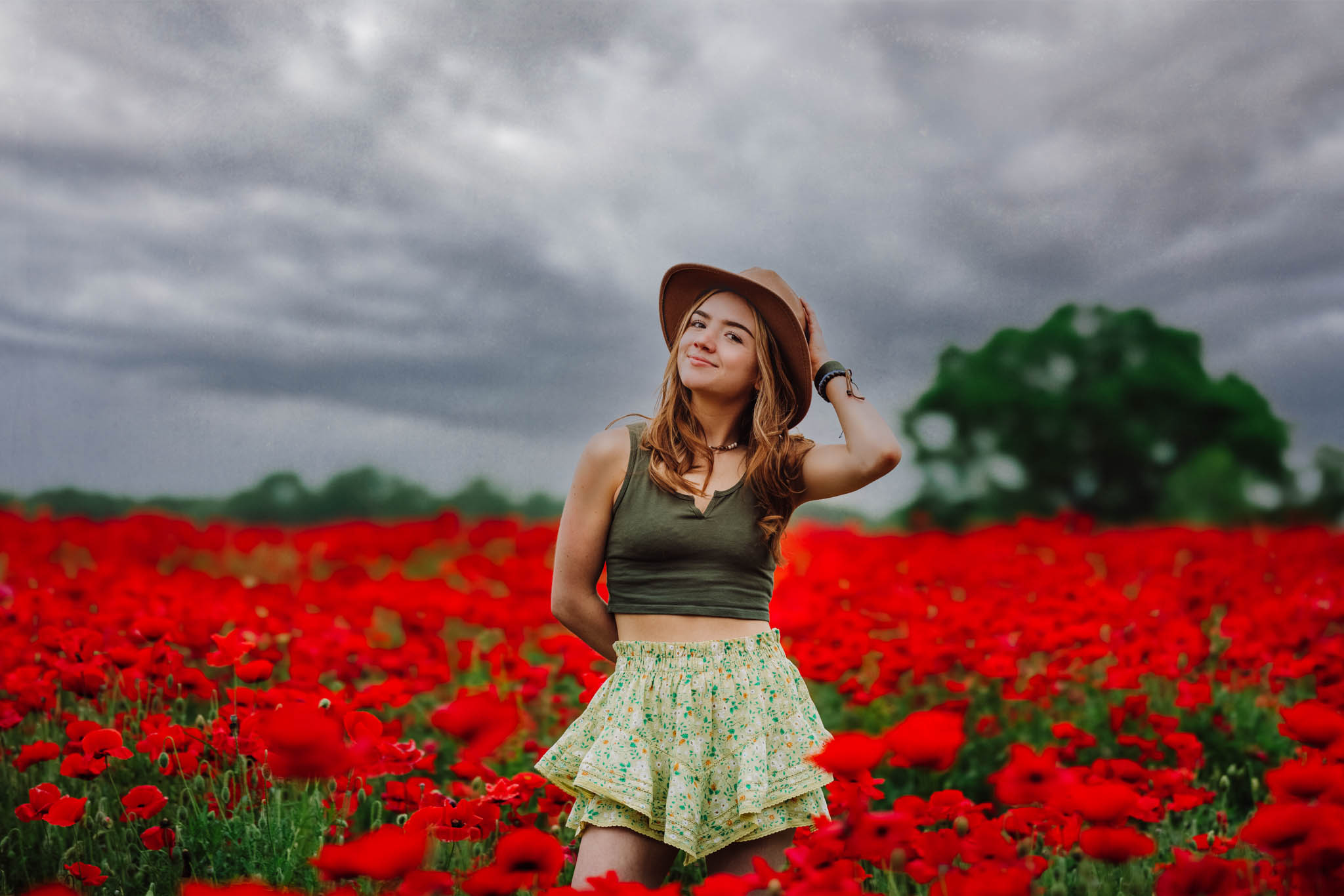 teenage girl in a field or red poppies