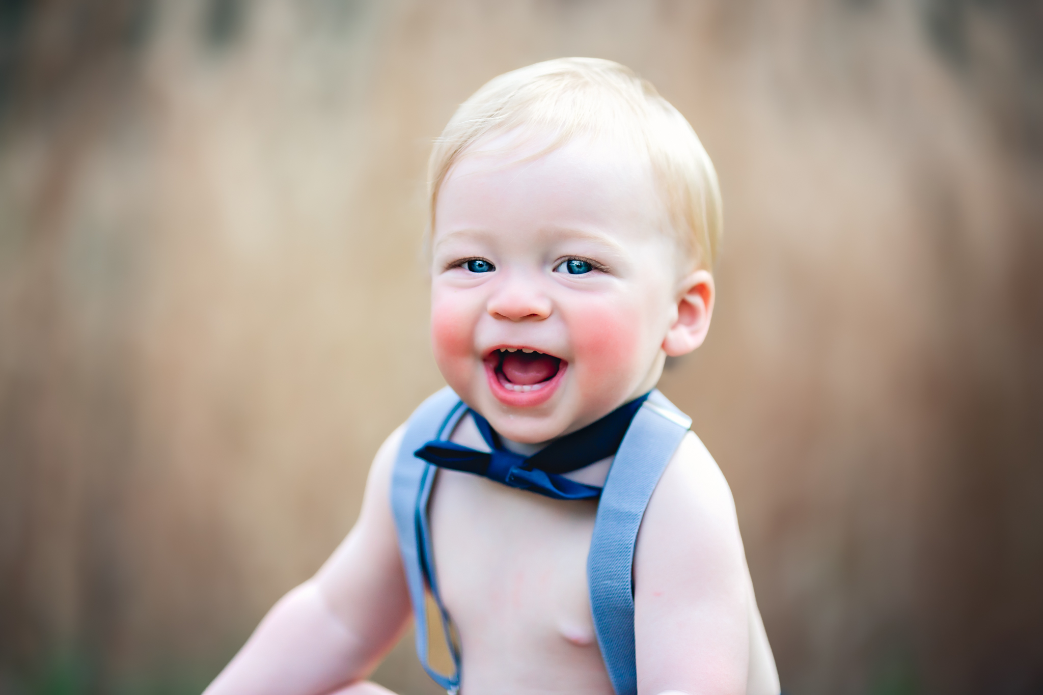 Baby boy smiling with big blue eyes