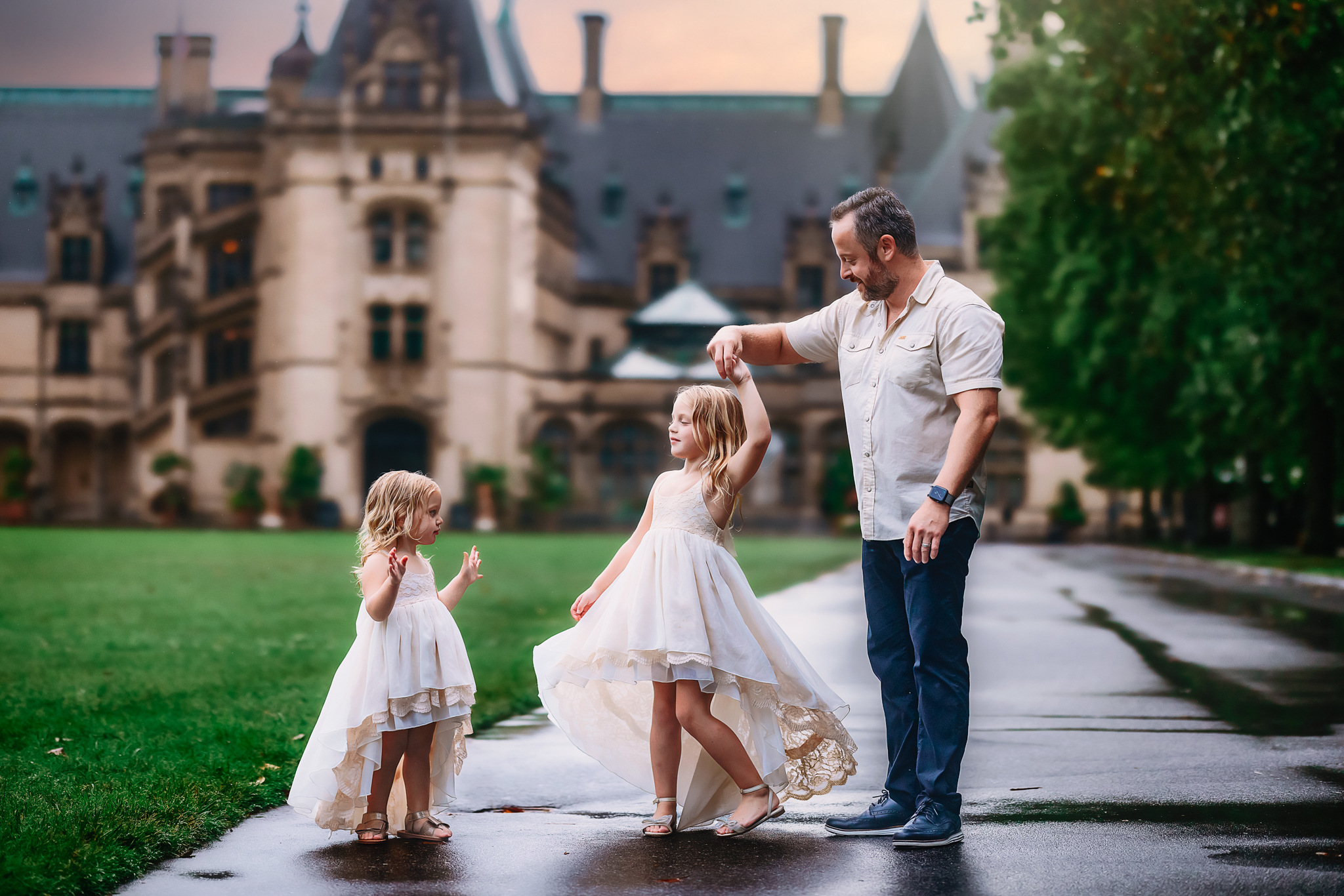 dad dancing with his little girls in front of the biltmore estates, Asheville, NC