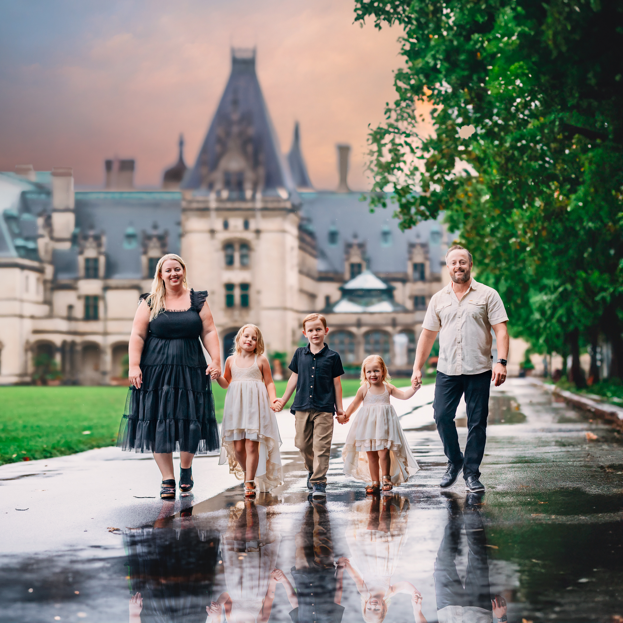 family walking holding hands in front of the biltmore estates, asheville, NC