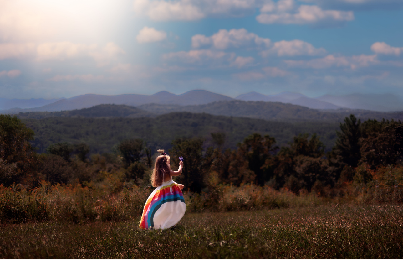 Little girl in a rainbow dress overlooking the mountains of Asheville, NC